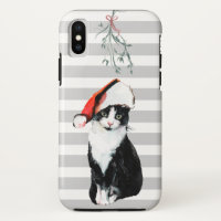 Chat de Noël noir et blanc portant un chapeau de s
