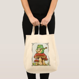 Cottagecore kikker met paddestoelhuis die banjo sp tote bag