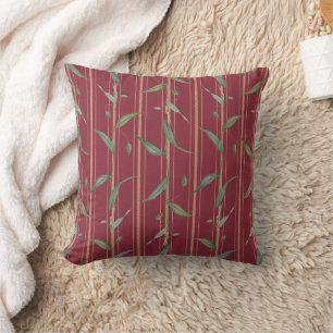 Coussin Branche de feuilles sur papier peint rouge
