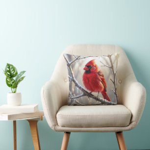 Coussin Cardinal perché sur une branche d'hiver avec des g