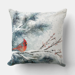 Coussin Cardinal rouge sur branche de pin enneigée