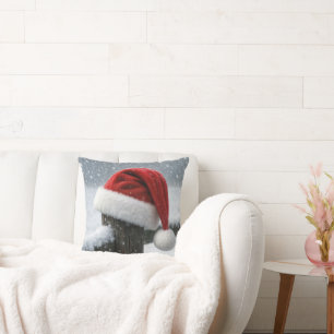 Coussin Chapeau de Père Noël sur un poteau de clôture enne