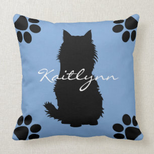 Coussin Chat noir et pattes pelucheux sur le bleu