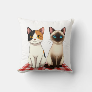 Coussin Chats mignons sur couverture à carreaux rouges