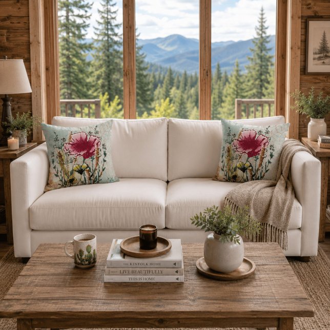Coussin décoratif botanique Fleur sauvage (White sofa with matching wildflower botanical throw pillows in a bright contemporary cabin.)