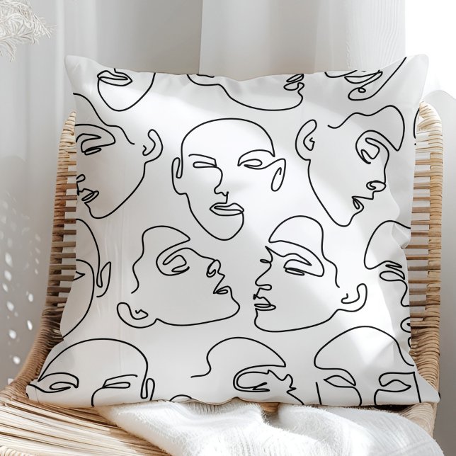 Coussin Dessin de visages au trait contemporain (Contemporary Line Art Drawing Faces Throw Pillow on a sunny rattan armchair.)