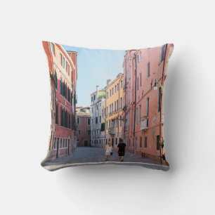 Coussin Femme en veste noire marchant sur le trottoir dans