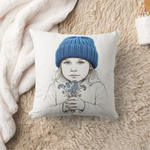 Coussin Fille avec un chapeau bleu tricoté