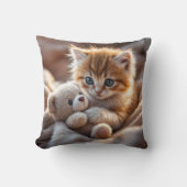 Coussin Fluffy red kitten playing with a tiny teddy bear,  (Recto)