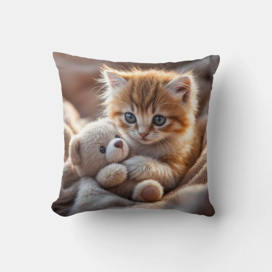 Coussin Fluffy red kitten playing with a tiny teddy bear, (Recto)