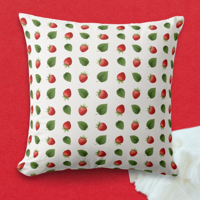 Coussin Fraises de fruits frais colorés Monogrammes (A throw pillow with pattern of red strawberries and green leaves on the front, monogram on the back)