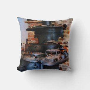 Coussin Irons Heating on Stove