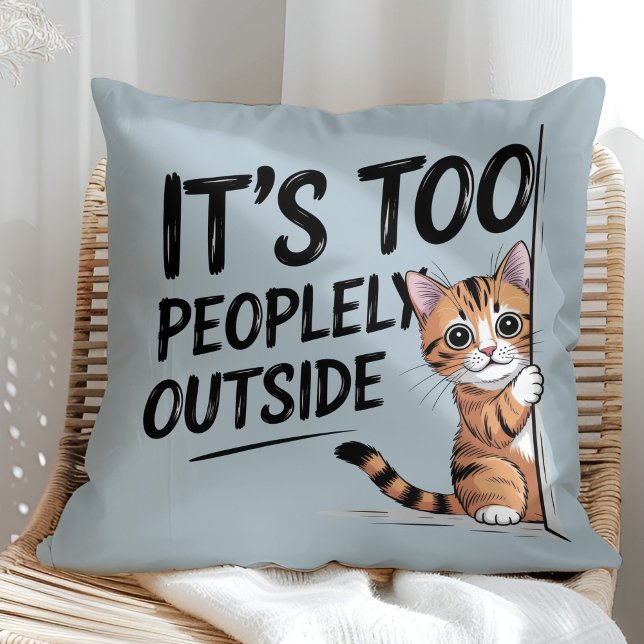 Coussin "It's Too Peopely Outside" Funny Introvert Cat ("It's Too Peopely Outside" Funny Introvert Cat Throw Pillow in a sunny boho rattan chair.)