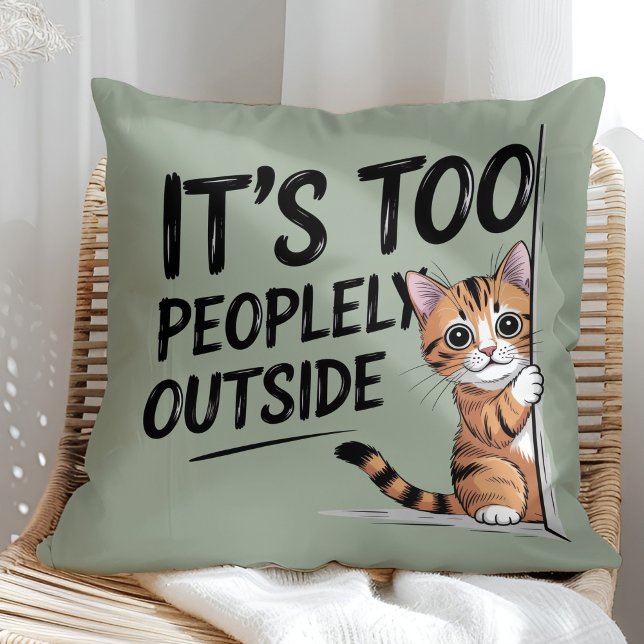 Coussin "It's Too Peopely Outside" Funny Introvert Cat ("It's Too Peopely Outside" Funny Introvert Cat Throw Pillow in a sunny boho rattan chair.)
