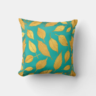 Coussin jeté bleu-vert avec feuilles dorées