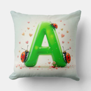 Coussin Jolies coccinelles sur la lettre verte de l'alphab