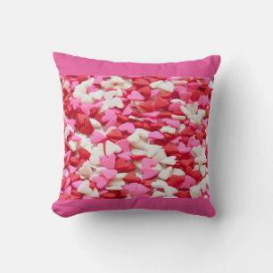 Coussin Le coeur rouge-rose arrose le motif de sucrerie