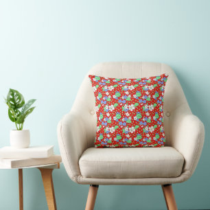 Coussin Lecteur rouge avec fleurs blanches et bleues