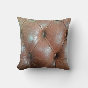 Coussin Lumière sur la surface du canapé en cuir marron, t