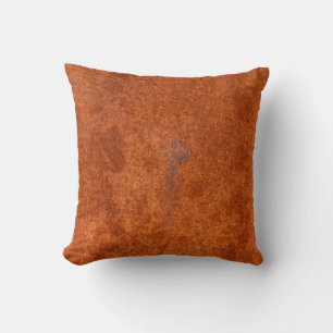 Coussin métal rouillé patiné : texture orange-rouge.