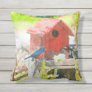 Coussin Oiseau bleu avec la volière rouge