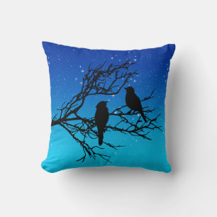 Coussin Oiseaux sur une branche, Noir contre le bleu du so
