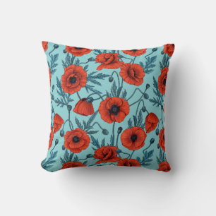 Coussin Poppies, rouge et bleu sur le bleu de la piscine