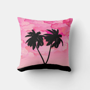 Coussin Silhouette de palmier contre l'aube rose avec nuag