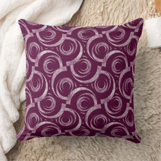 Coussin White ornament on a burgundy background.