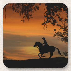 Cowboy rijdt in de zonsondergang onderzetters