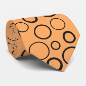 Cravate Bulles et anneaux, cercles noirs sur orange (Roulé)