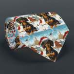 Cravate Dachshund Winter Wonderland Christmas Joy<br><div class="desc">Ce design festif reflète l'esprit joyeux de la période des fêtes, avec un adorable petit portant un chapeau de Père Noël. Le chien est niché dans un pays des merveilles hivernales, avec un bonhomme de neige, un sapin de Noël décoré et des cadeaux joliment emballés. Les flocons de neige tombent...</div>