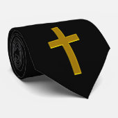 croix en or sur une cravate noire (Roulé)