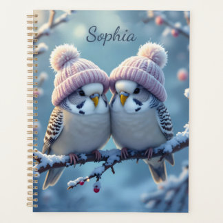 Cute budgies with bobble hats on a branch planner