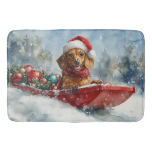 Dachshund-hond in slee laat het sneeuwen Kerstmis Badmat