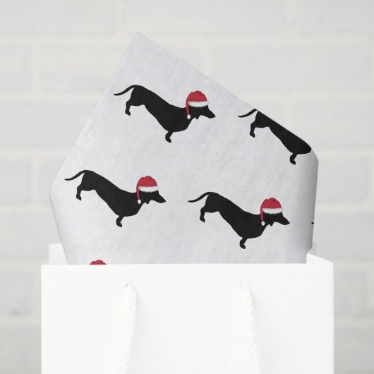 Dachshund in een kerstkerstman met kerstmis tissuepapier (Cadeauzakje)