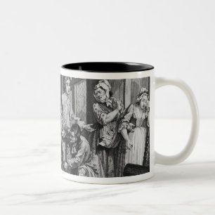 De jonge erfgenaam is in het bezit van tweekleurige koffiemok