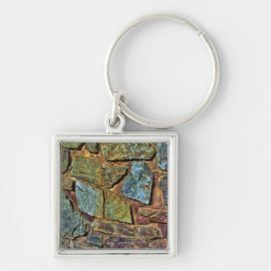 De oude kleurrijke textuur van de steenmuur sleutelhanger