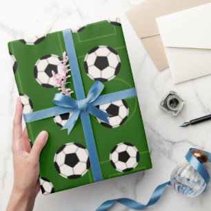 De partij verpakkend document van het voetbal en cadeaupapier