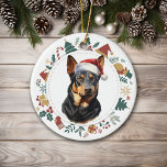 Décoration En Céramique Chapeau de Père Noël Chien Kelpie Australien Couro<br><div class="desc">Voici un ornement personnalisé mignon pour quiconque aime un chien Kelpie australien. Le devant représente un Kelpie noir et feu adorable portant un chapeau de Père Noël. L'image est encadrée dans une guirlande circulaire colorée composée de diverses images de vacances, y compris un bonhomme de neige, des cloches, un bâton...</div>