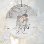 Décoration En Céramique First Christmas Engaged Custom Photo Gray Script<br><div class="desc">Commemorate your engagement with this beautiful modern keepsake ornament. The charcoal gray text reads "Our first Christmas engaged, " with the word "engaged" in elegant handwriting script with flourishes before and after. Replace the sample image with your favorite photo, and add your names and the year. A white gradient filter...</div>