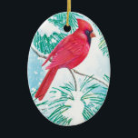 Décoration En Céramique Le Cardinal -<br><div class="desc">Cet ornement présente un beau cardinal rouge assis sur une branche enneigée d'un pin qui regarde les flocons de neige descendre du ciel pour couvrir le terrain d'une neige blanche.</div>