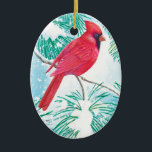 Décoration En Céramique Le Cardinal -<br><div class="desc">Cet ornement présente un beau cardinal rouge assis sur une branche enneigée d'un pin qui regarde les flocons de neige descendre du ciel pour couvrir le terrain d'une neige blanche.</div>