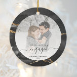 Décoration En Céramique Premier Noël Engagé Photo Black Agate<br><div class="desc">Commémorez votre fiançailles avec ce magnifique ornement photo de keepsaké moderne. Le texte noir indique "Notre premier Noël engagé", avec le mot "engagé" dans un script élégant avec des fioritures avant et après. La bordure présente un motif d'aquarelle noir orné d'une fausse parties scintillant dorée. Remplacez l'exemple d'image par votre...</div>