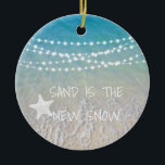 Décoration En Céramique Sand Is The New Snow Beach Christmas Ornament<br><div class="desc">This fun beach living design Sand is the new snow ornament features a beach scene with a sea-star and string lights handing across the top. Personalize by adding a year.</div>