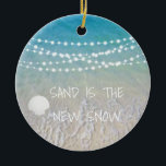 Décoration En Céramique Sand Is The New Snow Beach Christmas Ornament<br><div class="desc">This fun beach living design Sand is the new snow ornament features a beach scene with a seashell and string lights handing across the top. Personalize by adding a year.</div>