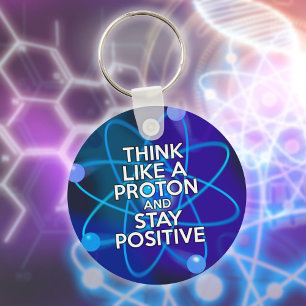 Denk als een proton en blijf positief leuk citaat sleutelhanger