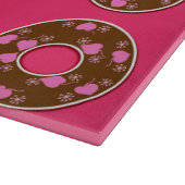 Dents de chocolat sur la planche à découper rose c (Coin)