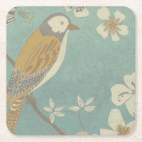 Oiseau jaune, gris et beige été perché sur une