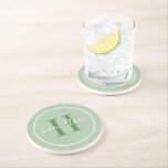 Dessous De Verre En Grès Élégant Sage Green Custom Monogramme initial<br><div class="desc">Elégante conception circulaire personnalisée de dessous de verre de boisson de boisson comprend un monogramme de serif classique personnalisé initial dans feuillage vert feuillu avec votre nom de famille dans le script moderne de calligraphie blanche contre un arrière - plan vert sage. Un simple cercle blanc encadre le design. Le...</div>